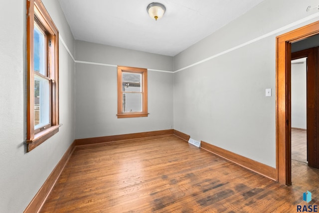 spare room featuring dark hardwood / wood-style flooring