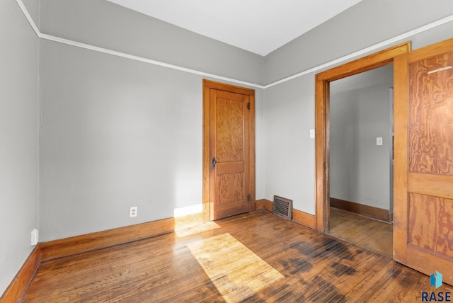 unfurnished bedroom featuring dark hardwood / wood-style floors