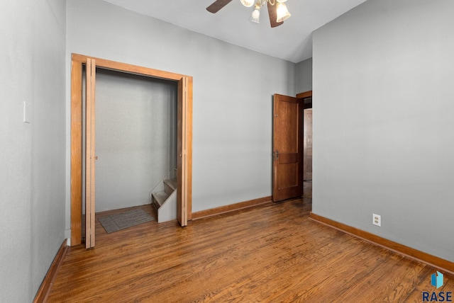 unfurnished bedroom featuring ceiling fan and wood-type flooring