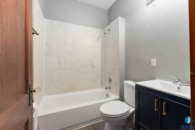 full bathroom with tiled shower / bath combo, vanity, and toilet