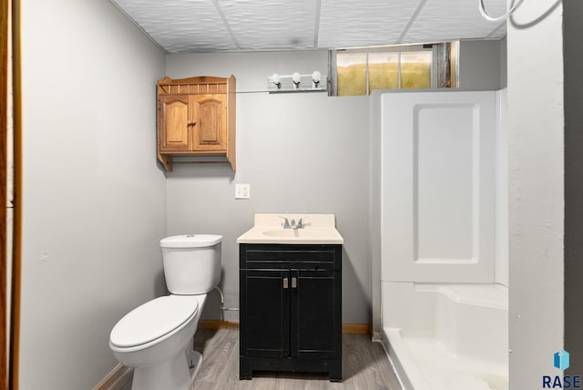 bathroom with toilet, hardwood / wood-style flooring, and vanity