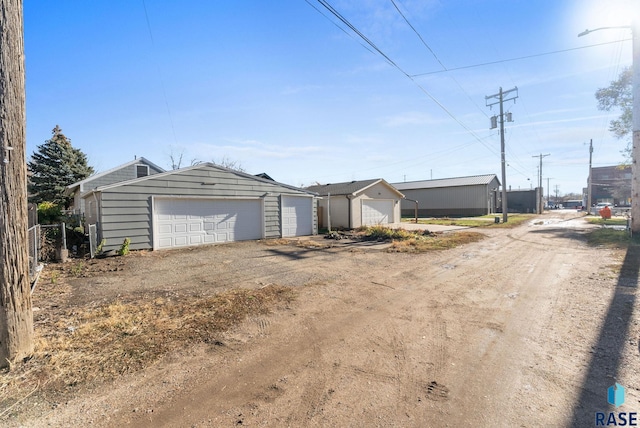 view of front facade with a garage and an outbuilding