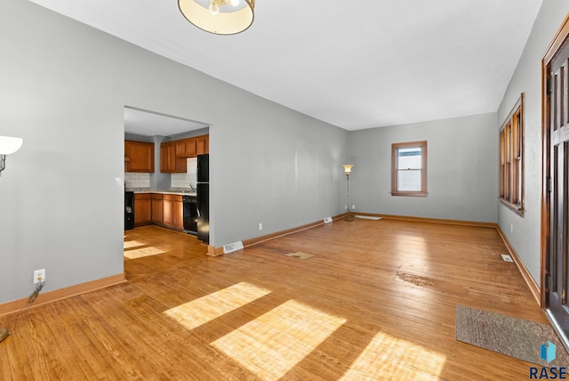 unfurnished living room with light wood-type flooring