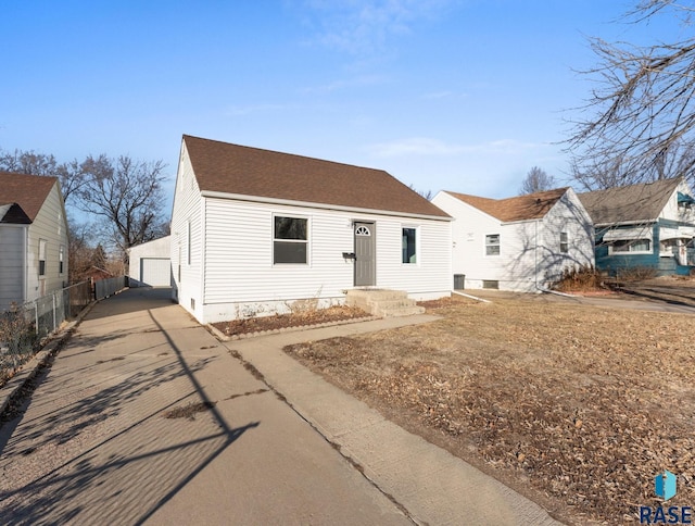 view of front of house featuring a garage and an outdoor structure