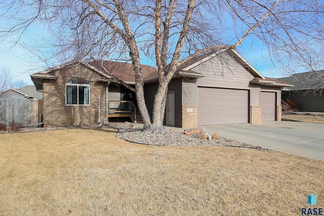 ranch-style home featuring brick siding, concrete driveway, a front yard, fence, and a garage