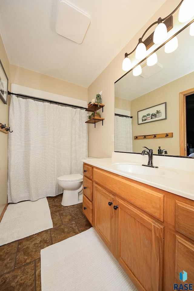 bathroom with toilet and vanity