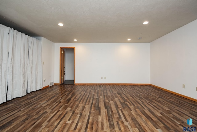 unfurnished room featuring baseboards, wood finished floors, and recessed lighting