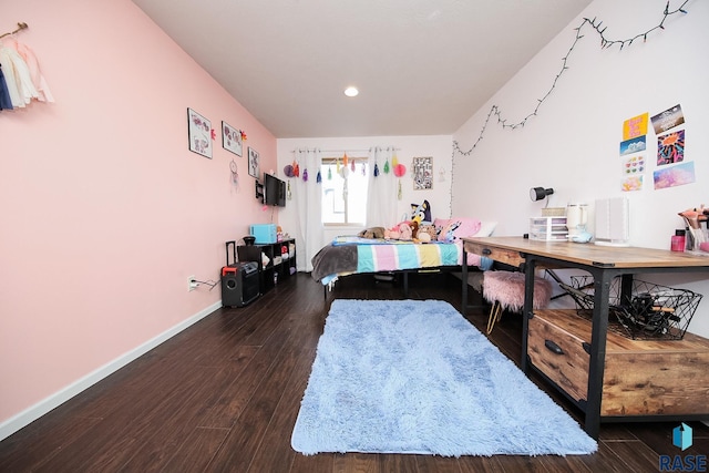 bedroom featuring baseboards and dark wood-style flooring