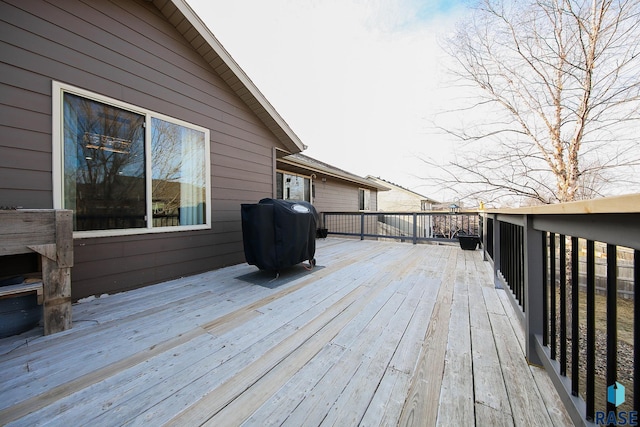 wooden terrace featuring a grill