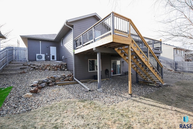 back of house with a deck, ac unit, fence, and stairway