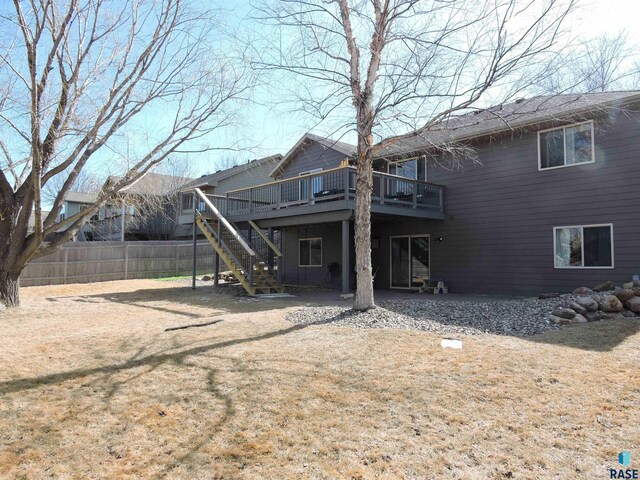 back of house with stairs, fence, and a deck