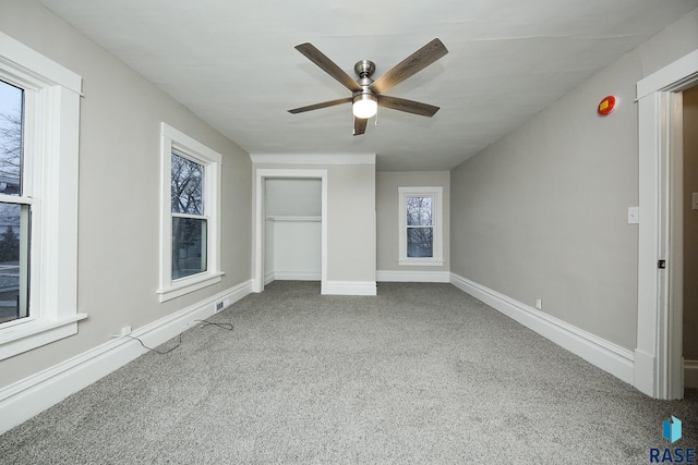 unfurnished bedroom featuring ceiling fan and carpet floors