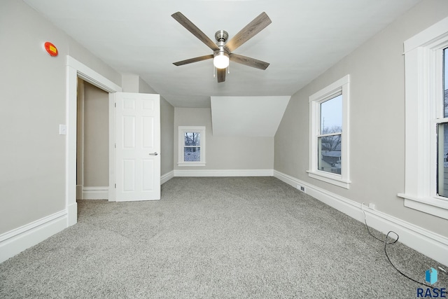 additional living space with carpet floors, vaulted ceiling, and ceiling fan