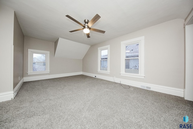 bonus room with vaulted ceiling, carpet flooring, and ceiling fan