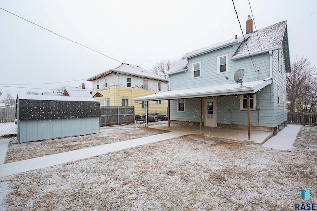 back of property featuring a storage shed