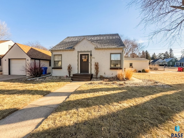 view of front of home with a garage and a front lawn