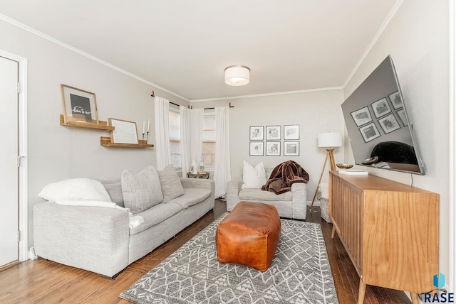 living room featuring hardwood / wood-style flooring and crown molding