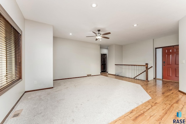 unfurnished room with ceiling fan and wood-type flooring