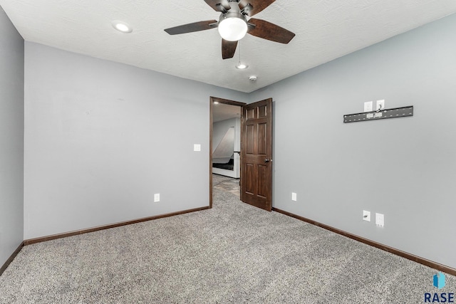 unfurnished bedroom featuring a textured ceiling, carpet flooring, and ceiling fan