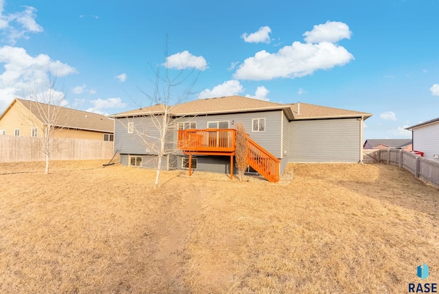 rear view of house featuring a wooden deck