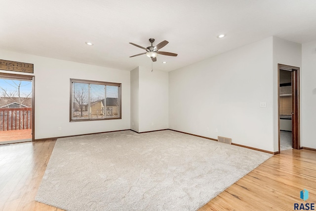 empty room featuring light wood-type flooring and ceiling fan