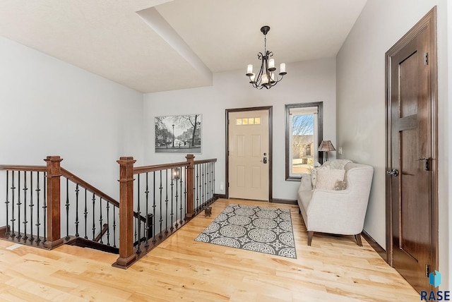 entryway featuring hardwood / wood-style flooring and a chandelier