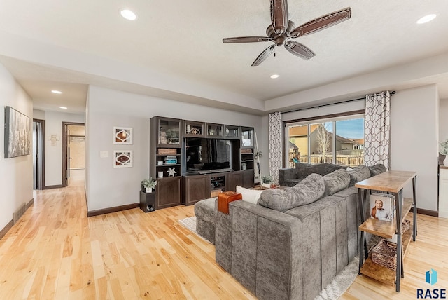 living room with light wood-type flooring and ceiling fan