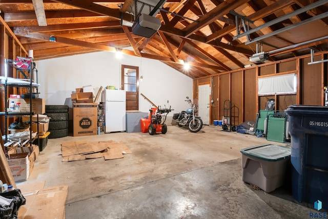 garage featuring a garage door opener and white fridge