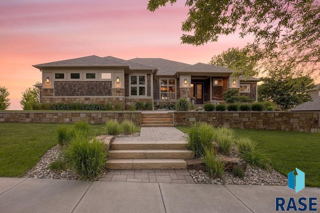 prairie-style home featuring a lawn