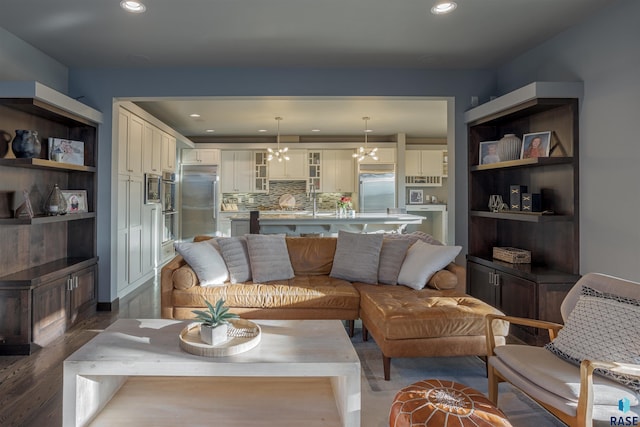 living room featuring an inviting chandelier and dark hardwood / wood-style floors