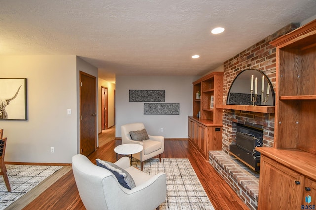 living room with a textured ceiling and dark hardwood / wood-style floors