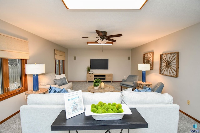 living room featuring carpet floors and ceiling fan