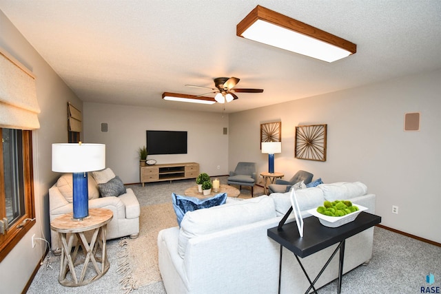 living room with carpet floors, a textured ceiling, and ceiling fan