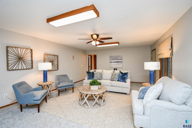 living room with ceiling fan and carpet