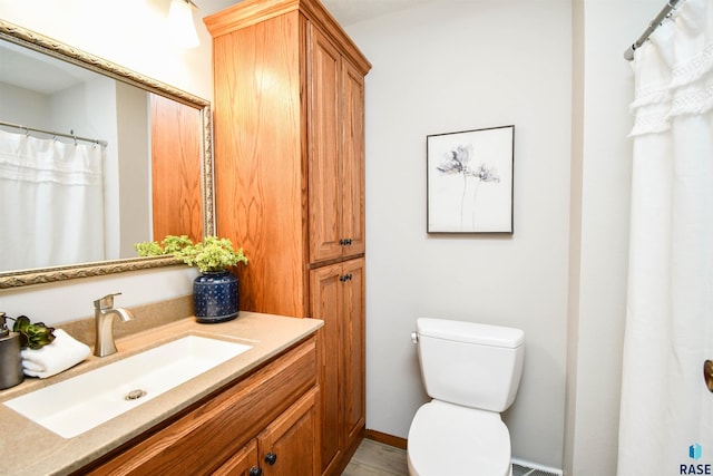 bathroom with toilet and vanity