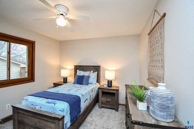 bedroom featuring light carpet and ceiling fan