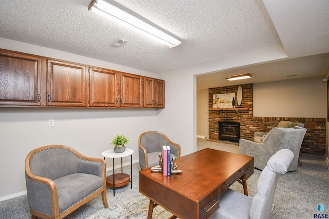 carpeted office with a textured ceiling, brick wall, and a wood stove