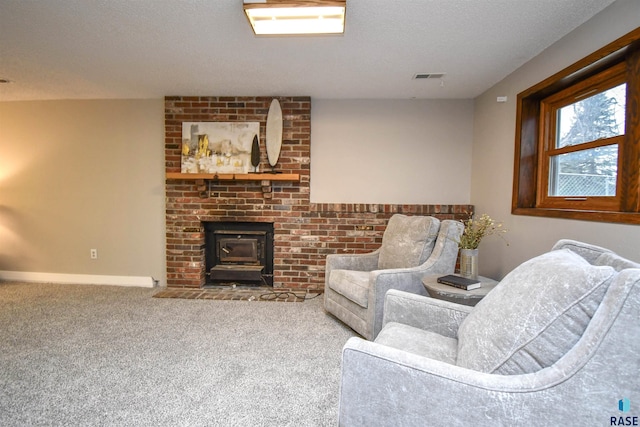 carpeted living room with a wood stove and a textured ceiling