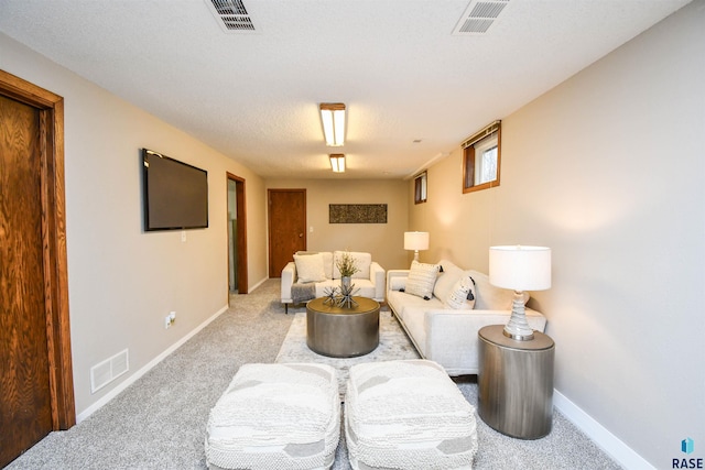 living room featuring light colored carpet and a textured ceiling