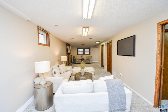 carpeted living room featuring plenty of natural light and a textured ceiling