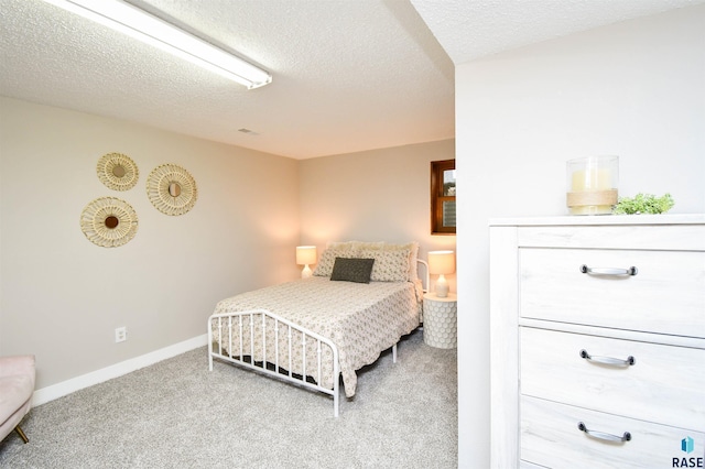 bedroom featuring a textured ceiling and carpet floors