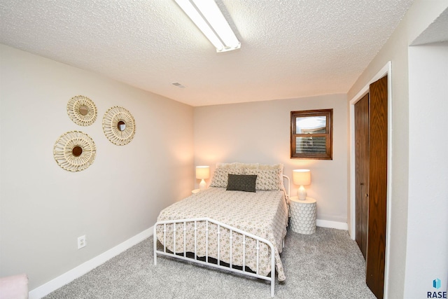 carpeted bedroom with a textured ceiling