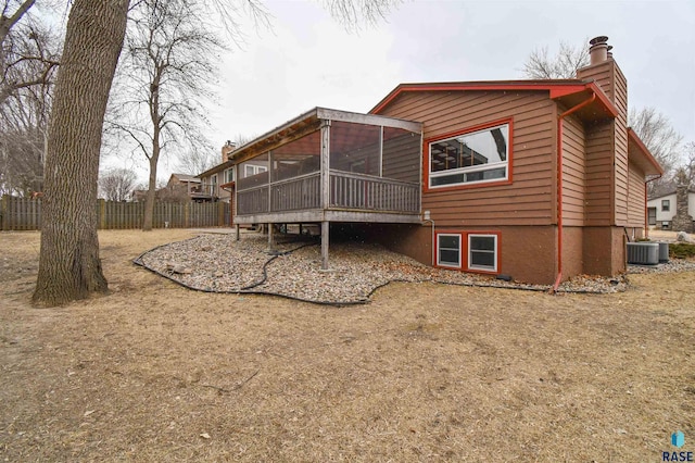 back of property with a sunroom and cooling unit