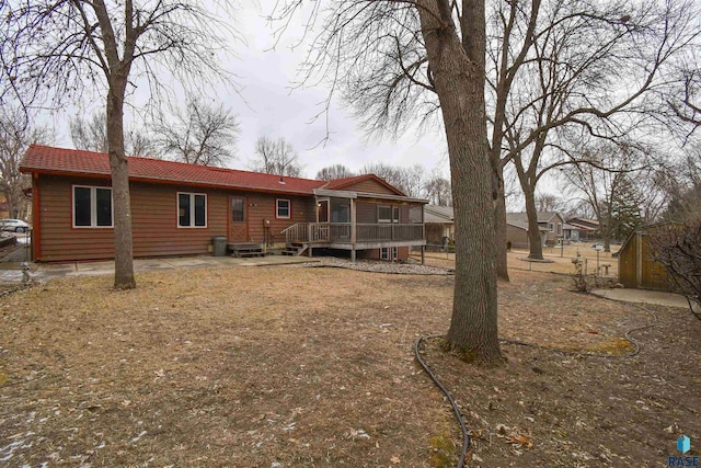 back of house with a wooden deck