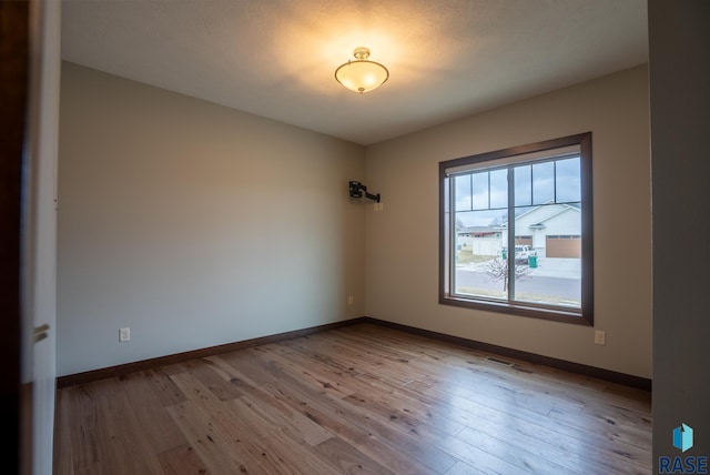 spare room with light hardwood / wood-style floors