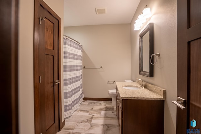 bathroom featuring toilet and vanity