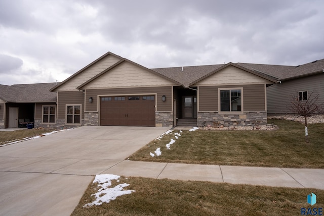 craftsman inspired home with a garage and a front yard