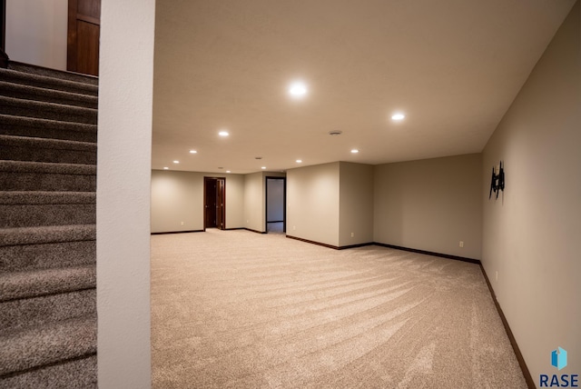 basement featuring light colored carpet