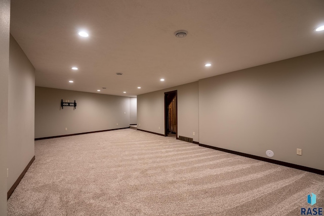 unfurnished room featuring light carpet