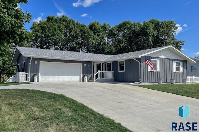 single story home with a garage and a front lawn